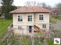Two-story house with a flat yard and stone outbuildings in the village of Stefan Stambolovo