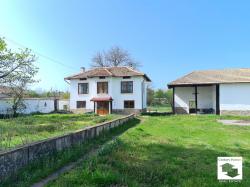 Two-story house with a flat yard and outbuildings in the village of Resen